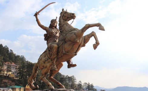 Sculpture of Rani Lakshmi Bai, fighting his enemies with his adopted son at back.